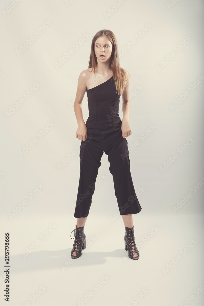 Fashionable girl in light tones in studio. Woman with unflappable face. Lifestyle concept in fashion world. Female in suit Fashionable girl in light tones in studio. Woman with unflappable face. Lifestyle concept in fashion world. Female in suit