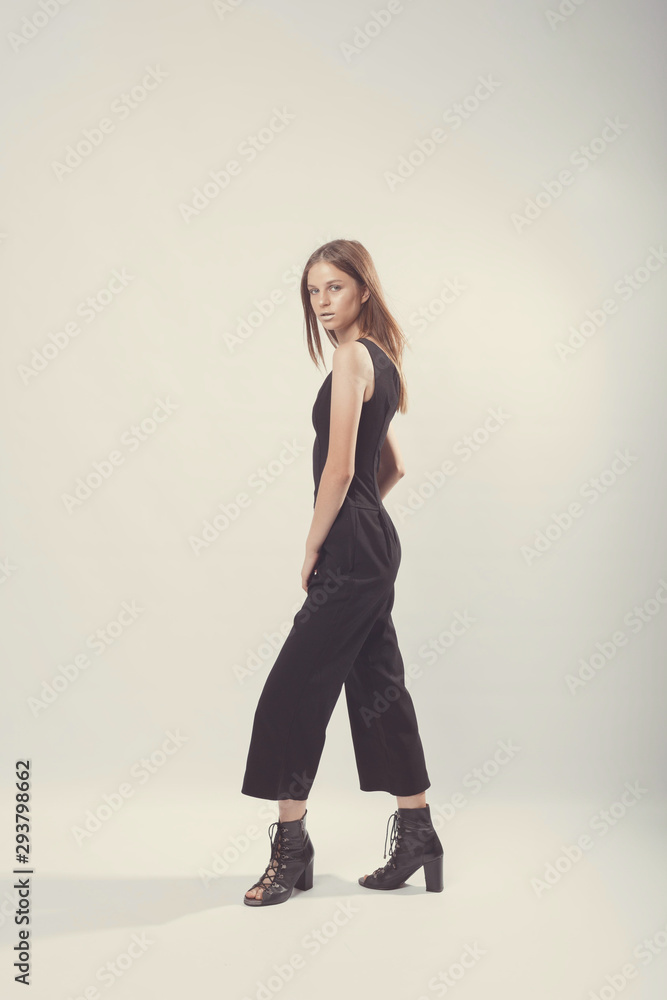 Fashionable girl in light tones in studio. Woman with unflappable face. Lifestyle concept in fashion world. Female in suit Fashionable girl in light tones in studio. Woman with unflappable face. Lifestyle concept in fashion world. Female in suit