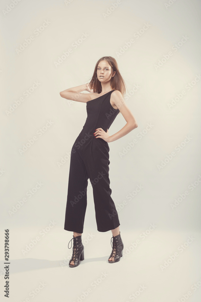 Fashionable girl in light tones in studio. Woman with unflappable face. Lifestyle concept in fashion world. Female in suit Fashionable girl in light tones in studio. Woman with unflappable face. Lifestyle concept in fashion world. Female in suit
