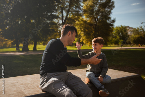 Hihg five - father and son in skate park