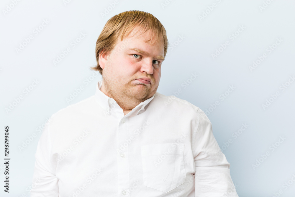 Young authentic redhead fat man confused, feels doubtful and unsure. Young authentic redhead fat man confused, feels doubtful and unsure.