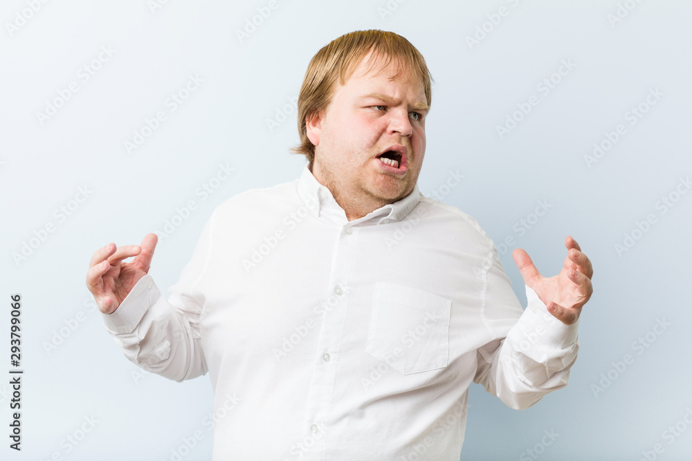Young authentic redhead fat man screaming with rage.