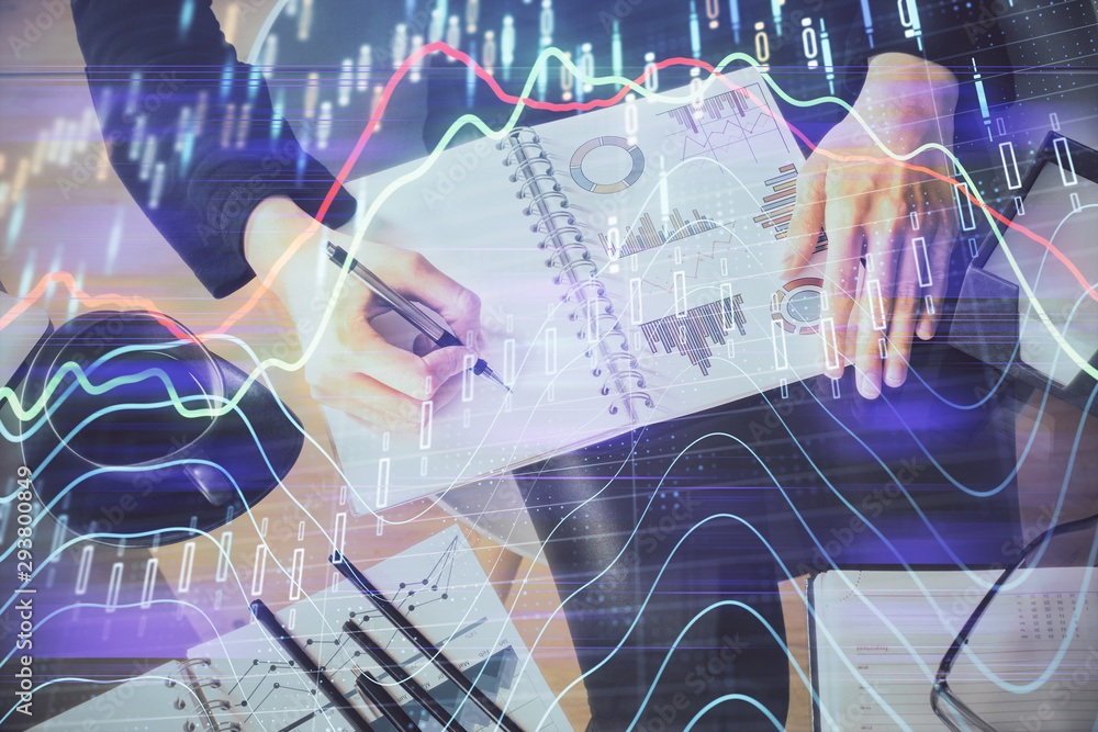 Multi exposure of hands making notes with forex chart huds. Stock market concept. Multi exposure of hands making notes with forex chart huds. Stock market concept.