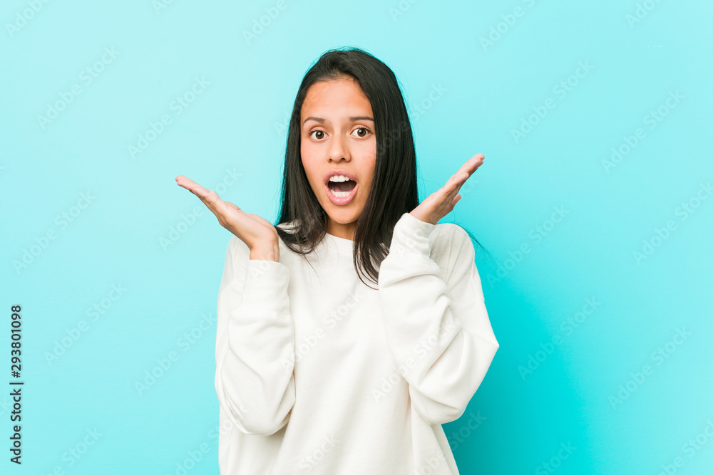 Young pretty hispanic woman surprised and shocked. Young pretty hispanic woman surprised and shocked.