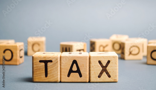 Wooden blocks with the word Tax. Business and finance concept. Taxes and taxation. The tax burden photo