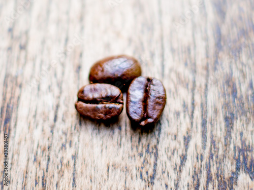 Coffee beans on the wooden table, ready to give freshness and alongside the businessman