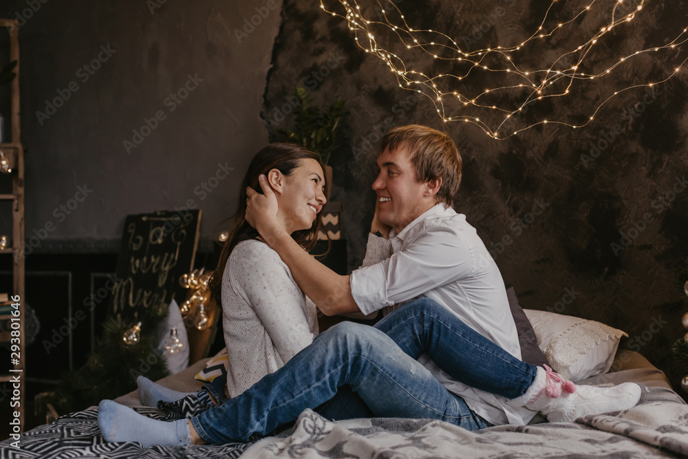 Naklejka premium Romantic couple in love feeling happiness about their romance spending christmas eve together- Image