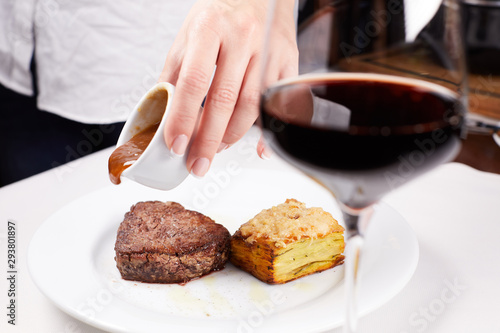 hand with knife and fork on plate