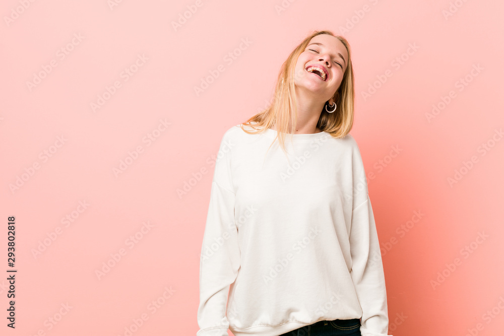 Obraz premium Young blonde teenager woman relaxed and happy laughing, neck stretched showing teeth.