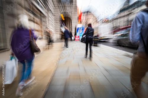 Motion blurred people walking on shopping street