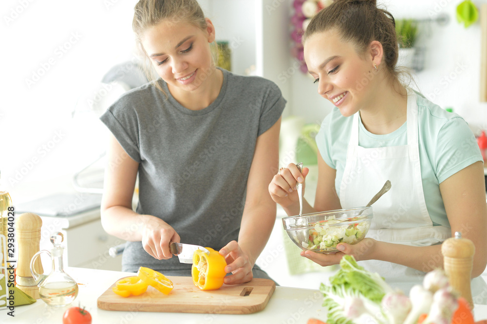 Portrait of a beautiful teenagers cooking in kitchen