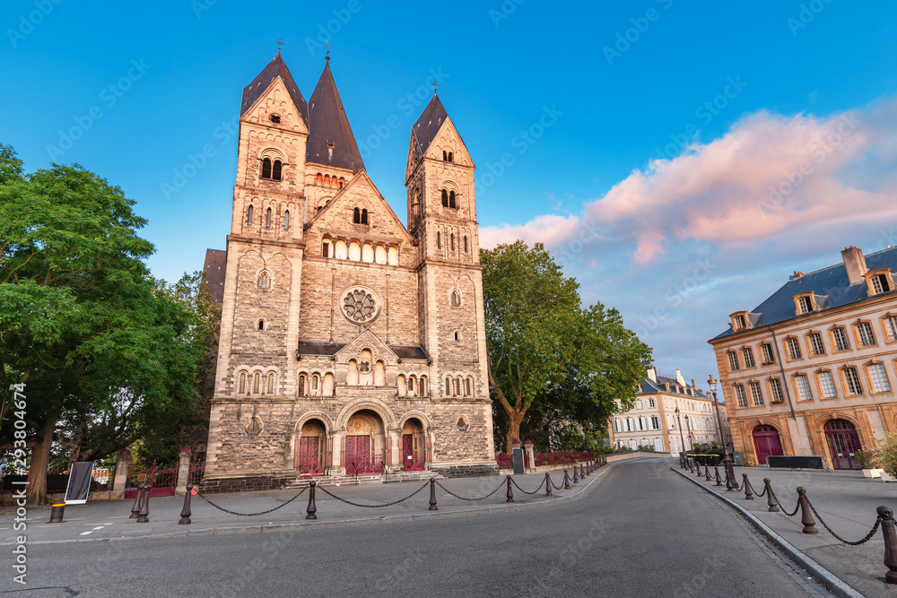 Travel to Metz - the capital of the Moselle region, France. The city street leads to the ancient Temple Neuf Church during the sunrise