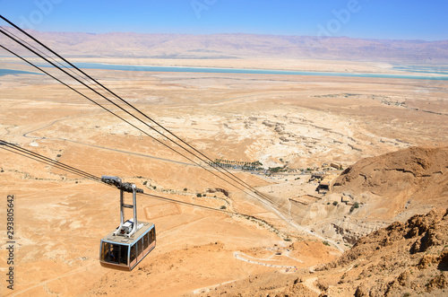 desert landscape of Israel with the dead sea in background and an cable car in the foreground