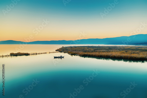 landscape with lake and mountains and boat