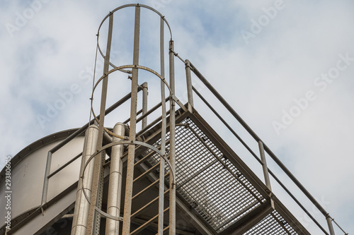 upper part of an industrial building with stairs, railings