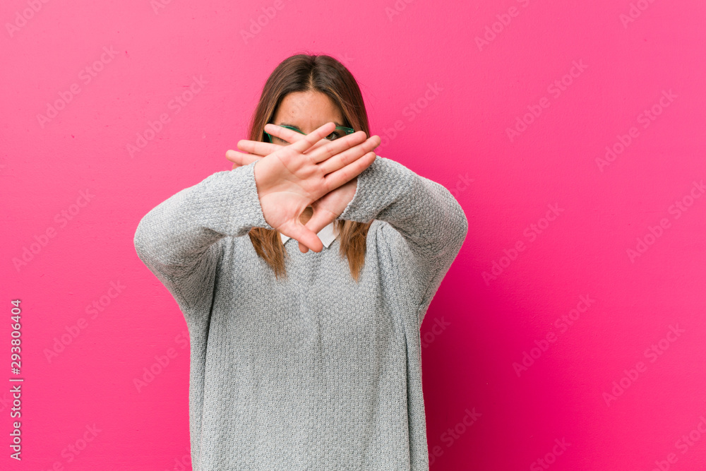 Young authentic charismatic real people woman against a wall doing a denial gesture Young authentic charismatic real people woman against a wall doing a denial gesture