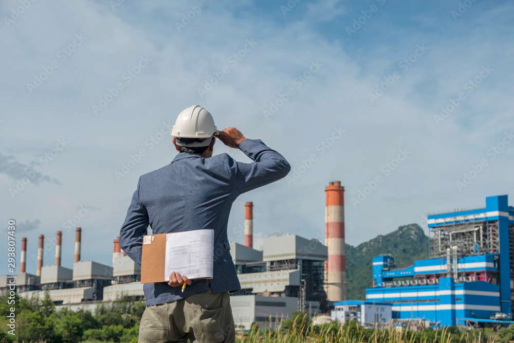 Businessmen at power plant background
