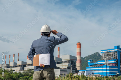Businessmen at power plant background