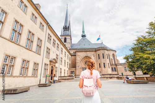 Tourist girl with backpack going to Notre Dame Cathedral in Luxembourg photo