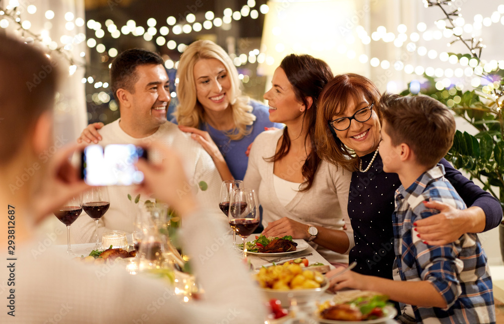 celebration, holidays and people concept - happy family having dinner party at home and taking selfie by smartphone celebration, holidays and people concept - happy family having dinner party at home and taking selfie by smartphone