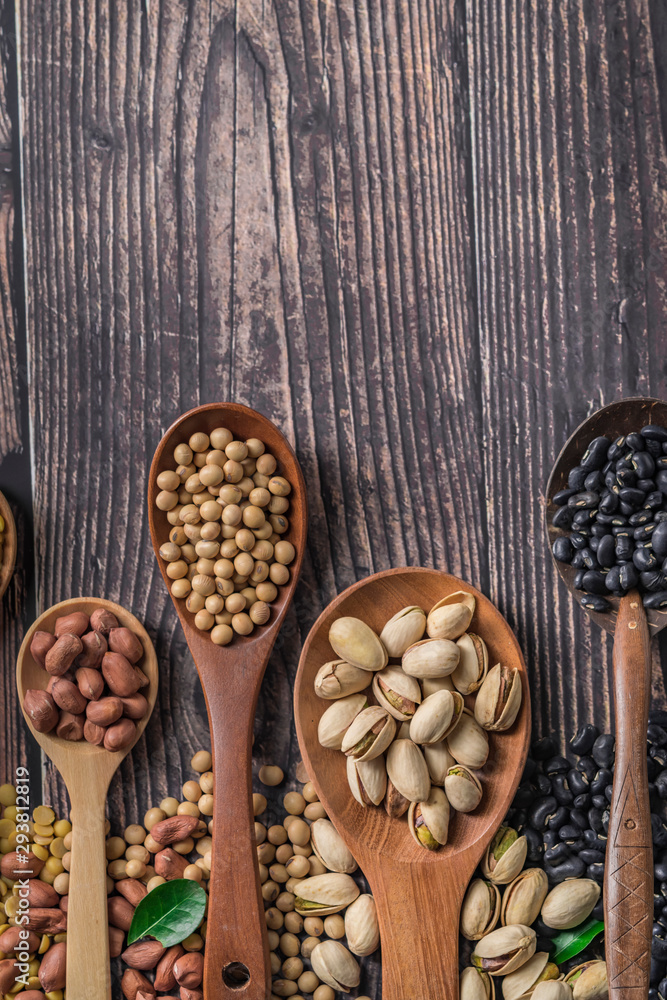 Mix of nuts in wooden spoon.