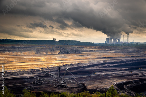 Mining equipment in a brown coal open-pit mine and a power plant with emission.