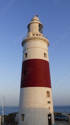 White and red lighthouse on the coast.
