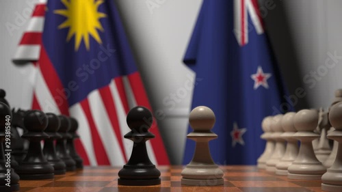 Flags of Malaysia and New Zealand behind pawns on the chessboard. Chess game or political rivalry related 3D animation photo