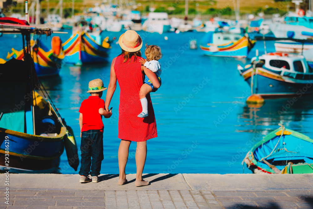 mother and kids looking at traditional boats in Malta - obrazy, fototapety, plakaty 