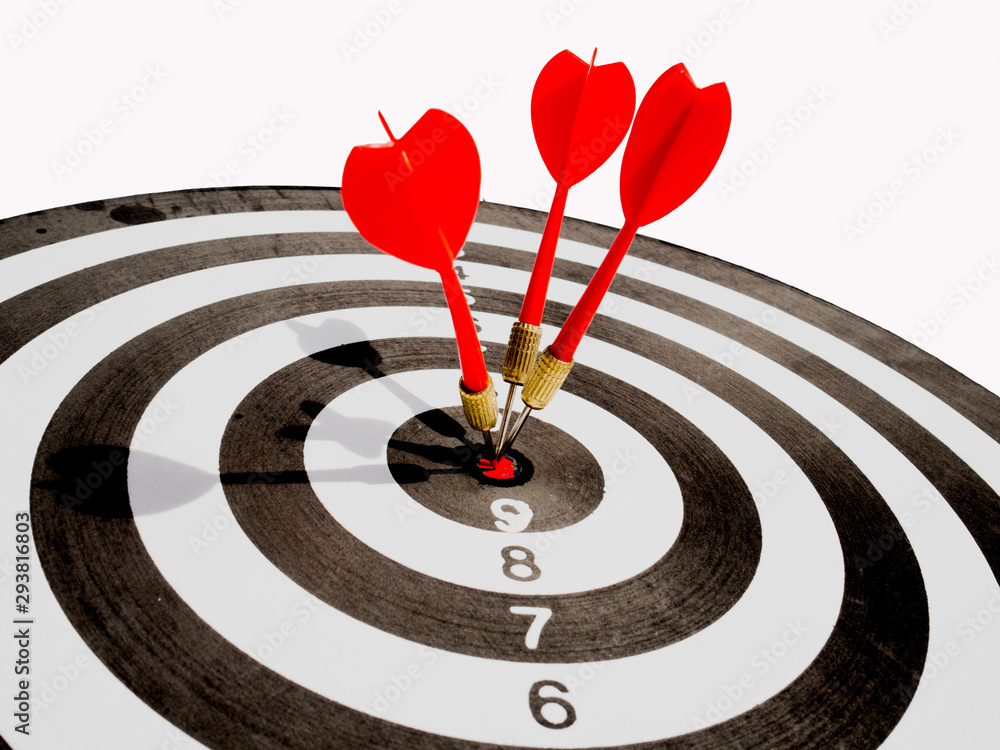 Target with three red dart focus on bull's eye, Setting challenging business goals And ready to achieve the goal with teamwork concept Target with three red dart focus on bull's eye, Setting challenging business goals And ready to achieve the goal with teamwork concept