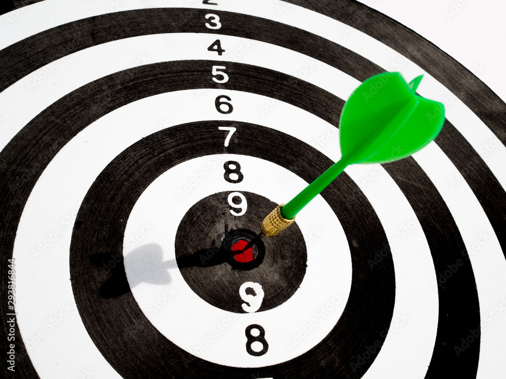 Target with green dart focus on bull's eye, Setting challenging business goals And ready to achieve the goal concept Target with green dart focus on bull's eye, Setting challenging business goals And ready to achieve the goal concept
