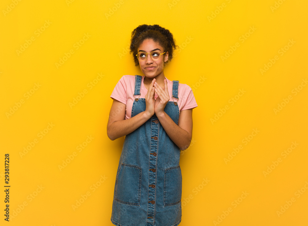 Young black african american girl with blue eyes devising a plan Young black african american girl with blue eyes devising a plan