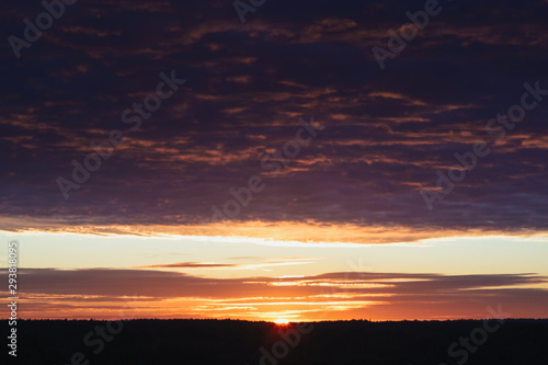 Dawn, field, colorful clouds, rising sun