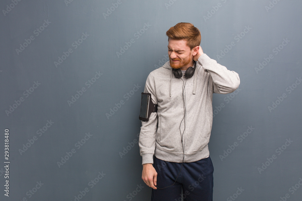Young fitness redhead man suffering neck pain Young fitness redhead man suffering neck pain