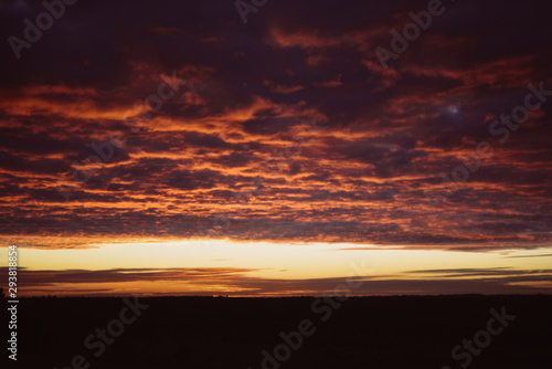 Dawn, field, colorful clouds, rising sun