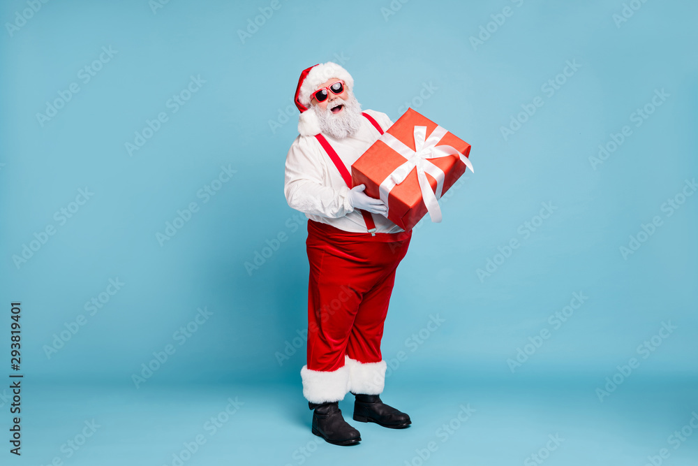 Full length photo of funny funky fat santa claus with big belly abdomen  hold gift box