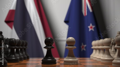 Flags of Thailand and New Zealand behind pawns on the chessboard. Chess game or political rivalry related 3D animation photo