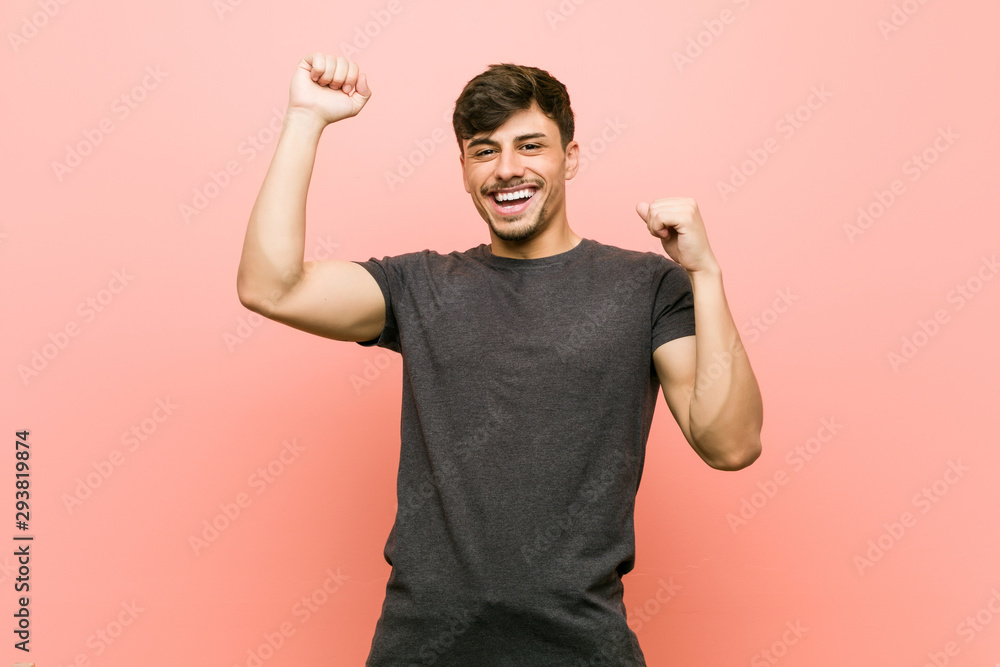 Young hispanic casual man celebrating a special day, jumps and raise arms with energy. Young hispanic casual man celebrating a special day, jumps and raise arms with energy.