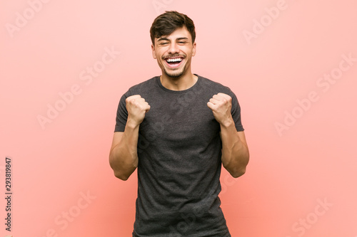 Young hispanic casual man cheering carefree and excited. Victory concept.