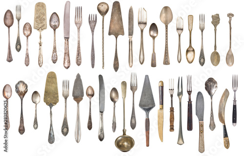 Top view of beautiful vintage silver knifes, spoons and forks  isolated on white background. Silverware.