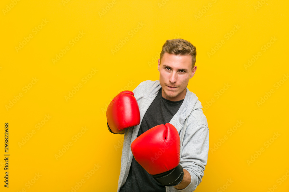 Young caucasian man wearing a boxing gloves Young caucasian man wearing a boxing gloves