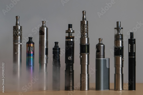 Collection of e-cigarettes or electronic cigarettes for liquid and vaping are displayed on clean backhground photo