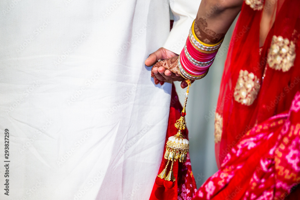 Indian hindu couple's holding hands on their wedding
