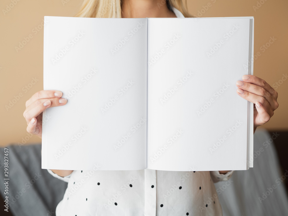 Front view woman holding a mock-up magazine Front view woman holding a mock-up magazine