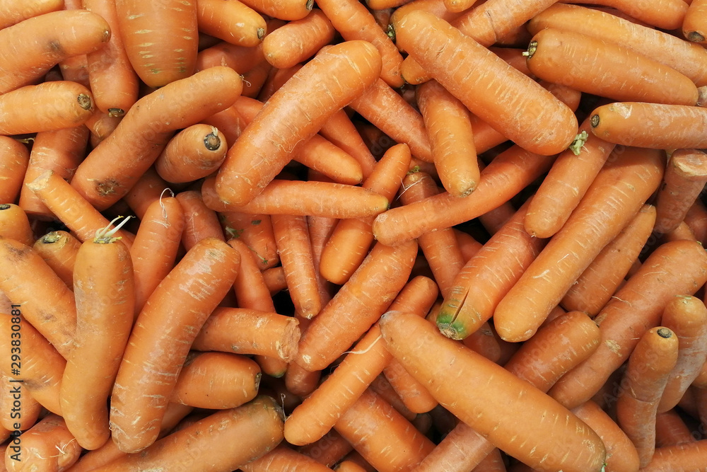Background of fresh carrot on the market stall. healthy ripe carrot for preparing meal. organic food texture Background of fresh carrot on the market stall. healthy ripe carrot for preparing meal. organic food texture