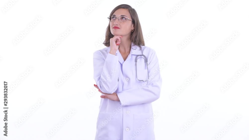 Happy beautiful woman doctor with eyeglasses thinking and looking up Happy beautiful woman doctor with eyeglasses thinking and looking up