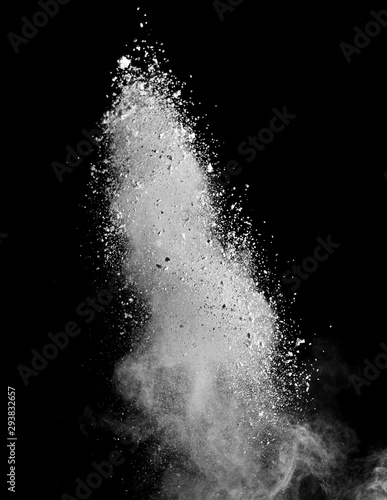 Fototapeta Naklejka Na Ścianę i Meble -  White powder splash isolated on black background. Flour sifting on a black background. Explosive powder white