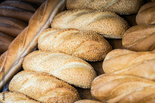 freshly baked bread of different types and varieties on the counter of the bakery