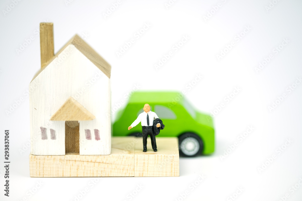 Miniature people : Banker stand with wooden home and wooden car. Miniature people : Banker stand with wooden home and wooden car.