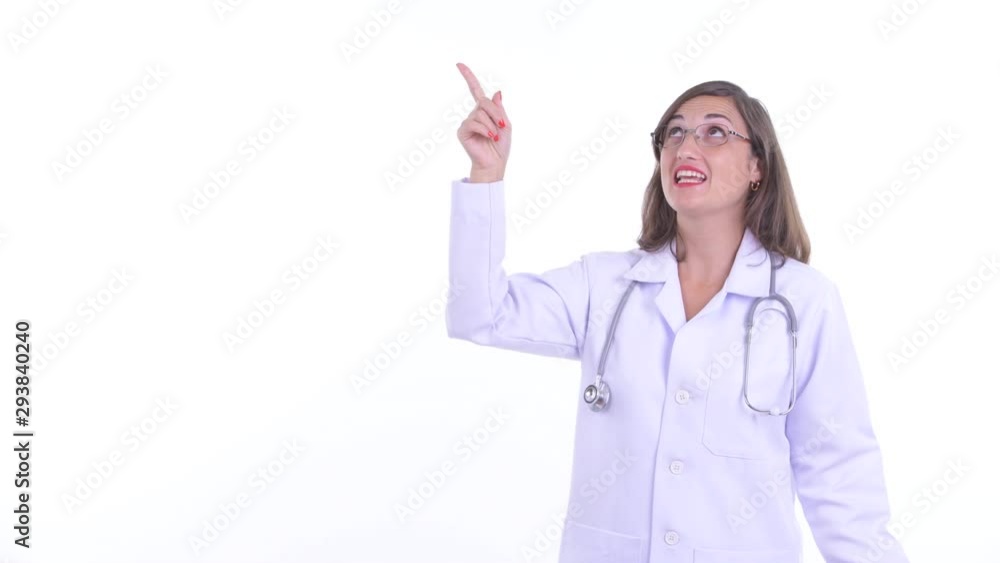 Happy beautiful woman doctor talking while pointing up Happy beautiful woman doctor talking while pointing up
